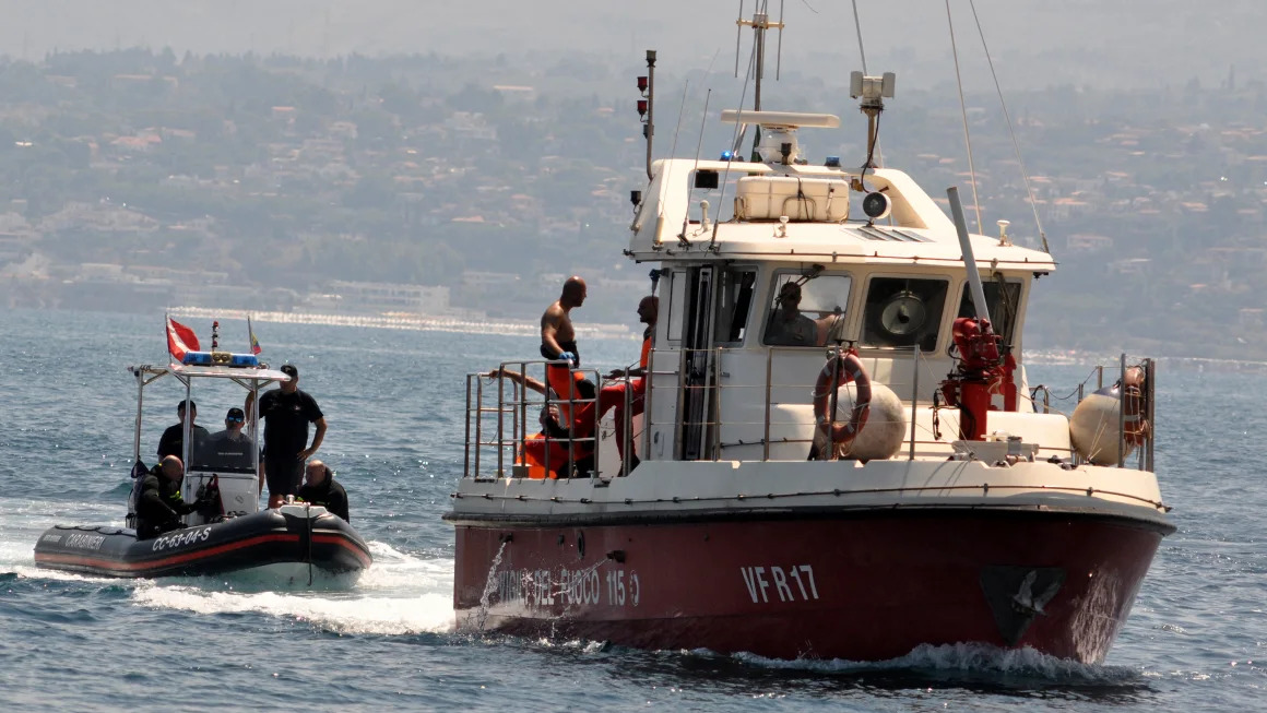 Superyatch sinking - Divers enter Porticello harbor near Palermo, with the body of Hannah Lynch at the back of the boat on.
